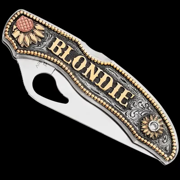 "Our hand-engraved Desert Bloom Custom Knife is the perfect addition to any cowboy or cowgirl's attire. This custom-made knife is crafted using a SpyderCo Byrd knife and a German Silver plate. The German Silver plate is hand-engraved & finished w